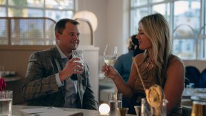 Couple enjoying a luxury dining experience inside a modern restaurant