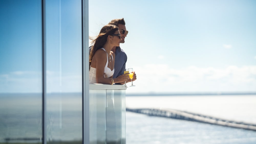 Couple enjoying drinks on a private balcony overlooking Tampa Bay at Marina Pointe