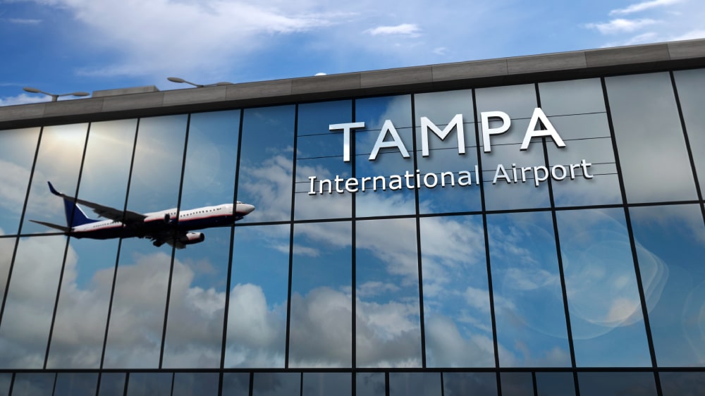 Airplane reflection on glass at Tampa International Airport terminal