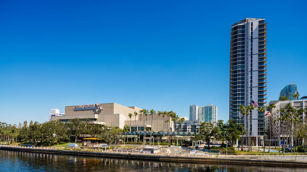 Exterior view of the Straz Center for the Performing Arts along the Tampa Riverwalk on a clear day.