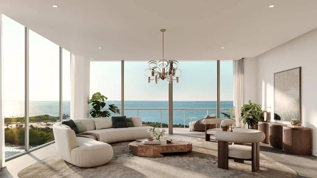Modern living room with large windows and ocean view.