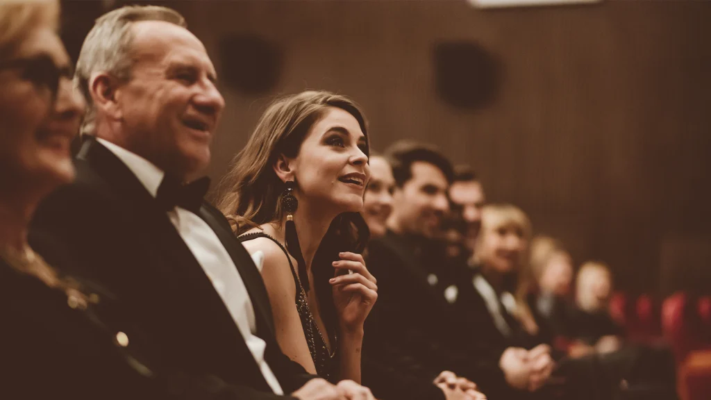 Audience members seated at a formal gala event.