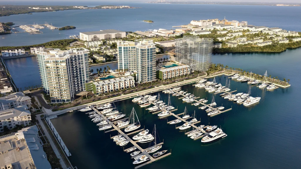 Aerial view of Marina Pointe waterfront community with towers, marina, and yachts
