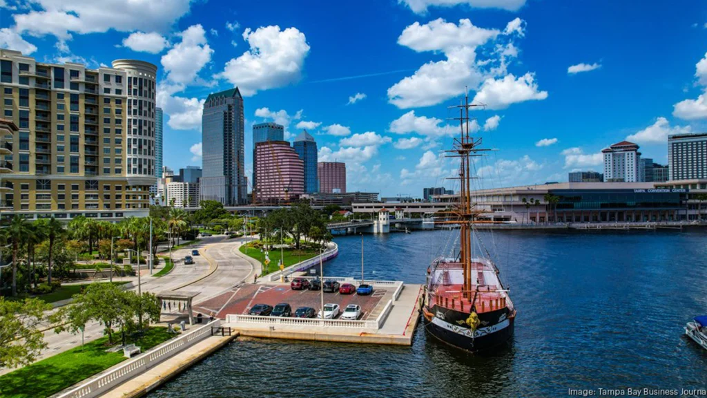 Downtown waterfront with skyline, marina, and docked ship
